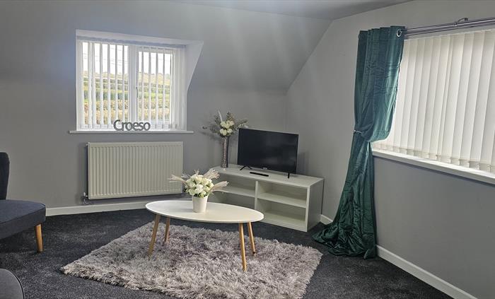 The Redford Cwtch Lounge – a cosy, welcoming space with soft seating, warm lighting, and rustic charm, perfect for relaxing with family or friends aft